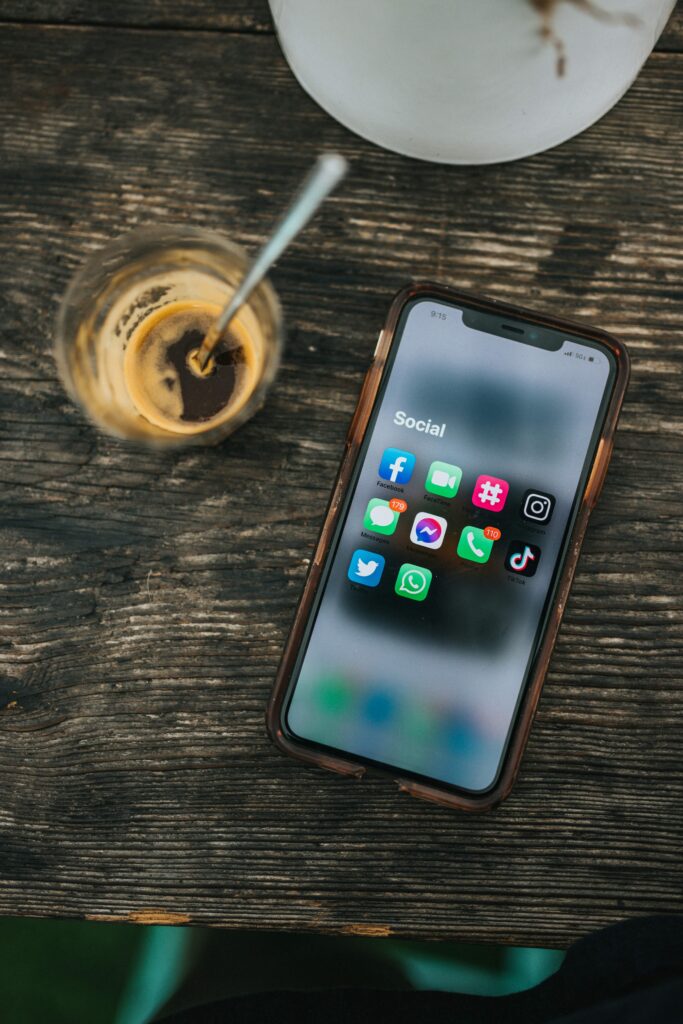 phone screen open on the social media folder on a coffee table