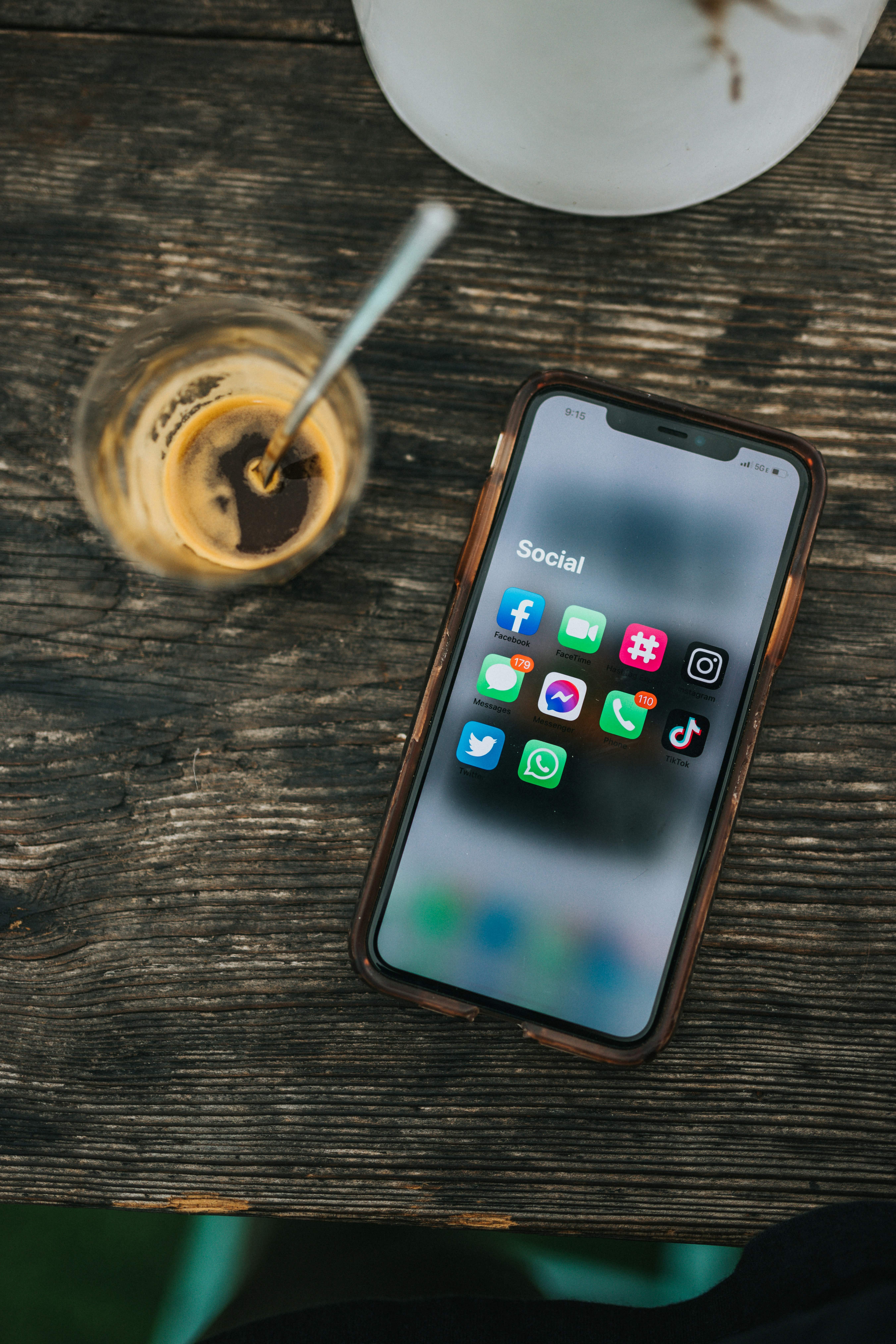 phone screen open on the social media folder on a coffee table